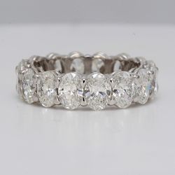 Eternity band in platinum with basket eagle claw set VS-SI1 (16) oval diamonds.  D5.05ct.t.w.  Size 5.5