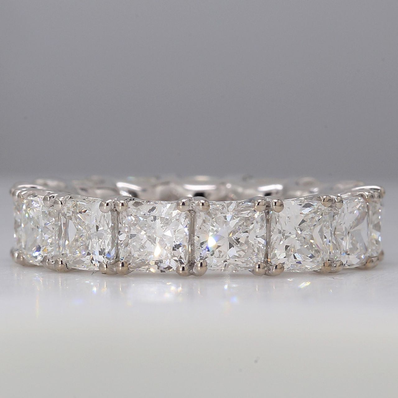 Eternity band in platinum with tulip setting G-H/VS-SI1 (15) cushion cut diamonds.  D7.96ct.t.w.  Size 5.5