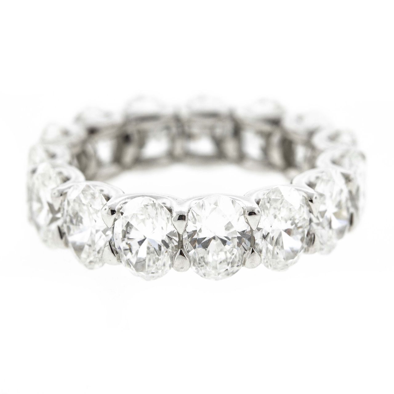 Eternity band in platinum with shared prong set GIA certified E-G/SI1-SI2 (15) oval diamonds .  D7.56ct.t.w.  Size 6.5