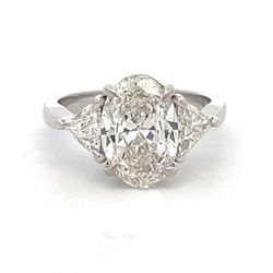 3-stone semi-mount in platinum with prong set trilliant diamond side stones.  D0.69ct.t.w.  Size 6.5