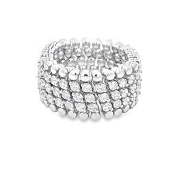 Flexible eternity band in 18K WG with prong set round diamonds.  D2.90ct.t.w.