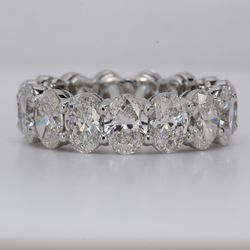 Eternity band in platinum with basket shared prong GIA certified D-F/SI1-SI2 (15) oval diamonds.  D7.71ct.t.w.  Size 6.5