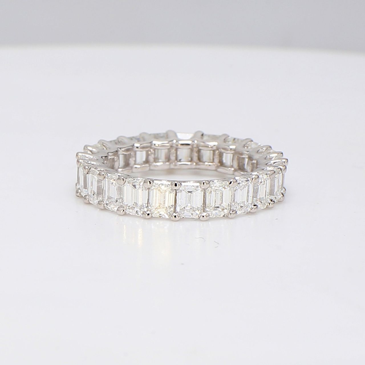 Eternity band in 18K WG with U-prong set emerald cut diamonds.  D3.38ct.t.w.  Size 4.25