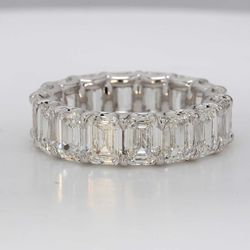 Eternity band in platinum with U-prong set GIA certified G-H/IF-VS (16) emerald cut diamonds.  D8.49ct.t.w.  Size 5.5