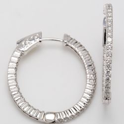 1' Oval shaped inside out hoop earrings with shared prong set round diamonds.  D1.42ct.t.w.