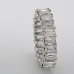 Eternity band in platinum with shared U-prong basket set (22) emerald cut diamonds.  D6.68ct.t.w.  Size 7.25