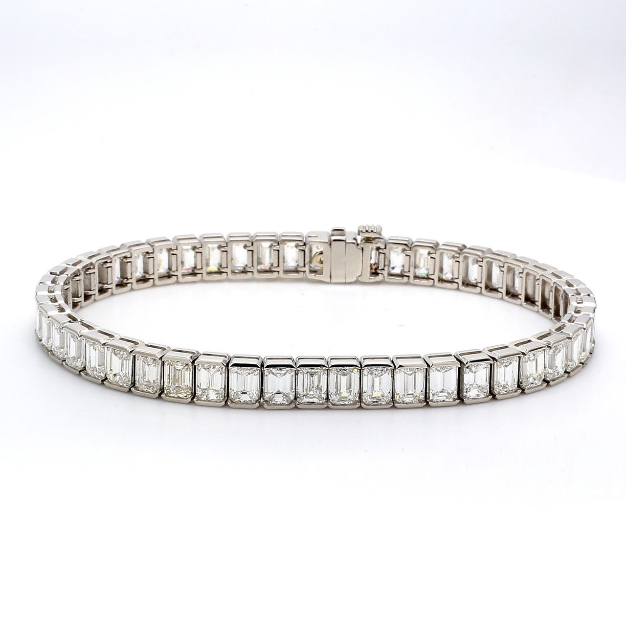 7' Tennis bracelet in platinum with channel set (50) emerald cut diamonds.  D15.90ct.t.w.