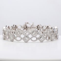 7' Designer bracelet in 18K WG with pre-set rounds & bezel set radiant cut diamonds.  D7.62ct.t.w.