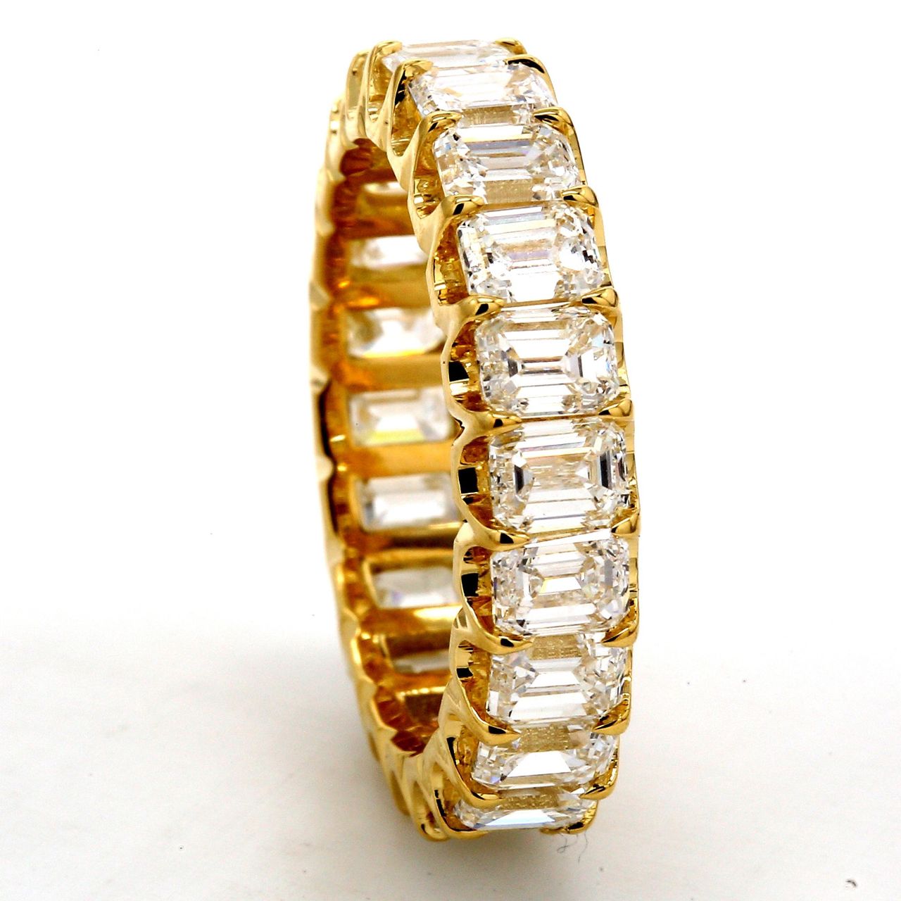 Eternity band in 18K YG with U-prong set (22) emerald cut diamonds.  D4.80ct.t.w.  Size 6