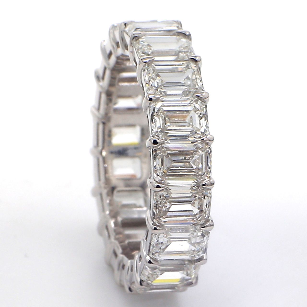 Eternity band in platinum with basket claw set GIA certified G-I/VVS1-VS2 (19) emerald cut diamonds.  D7.77ct.t.w.  Size 7
