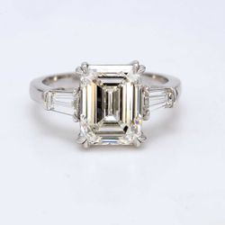 3-stone semi-mount in platinum with prong set tapered baguette diamond sides.  D0.63ct.t.w.