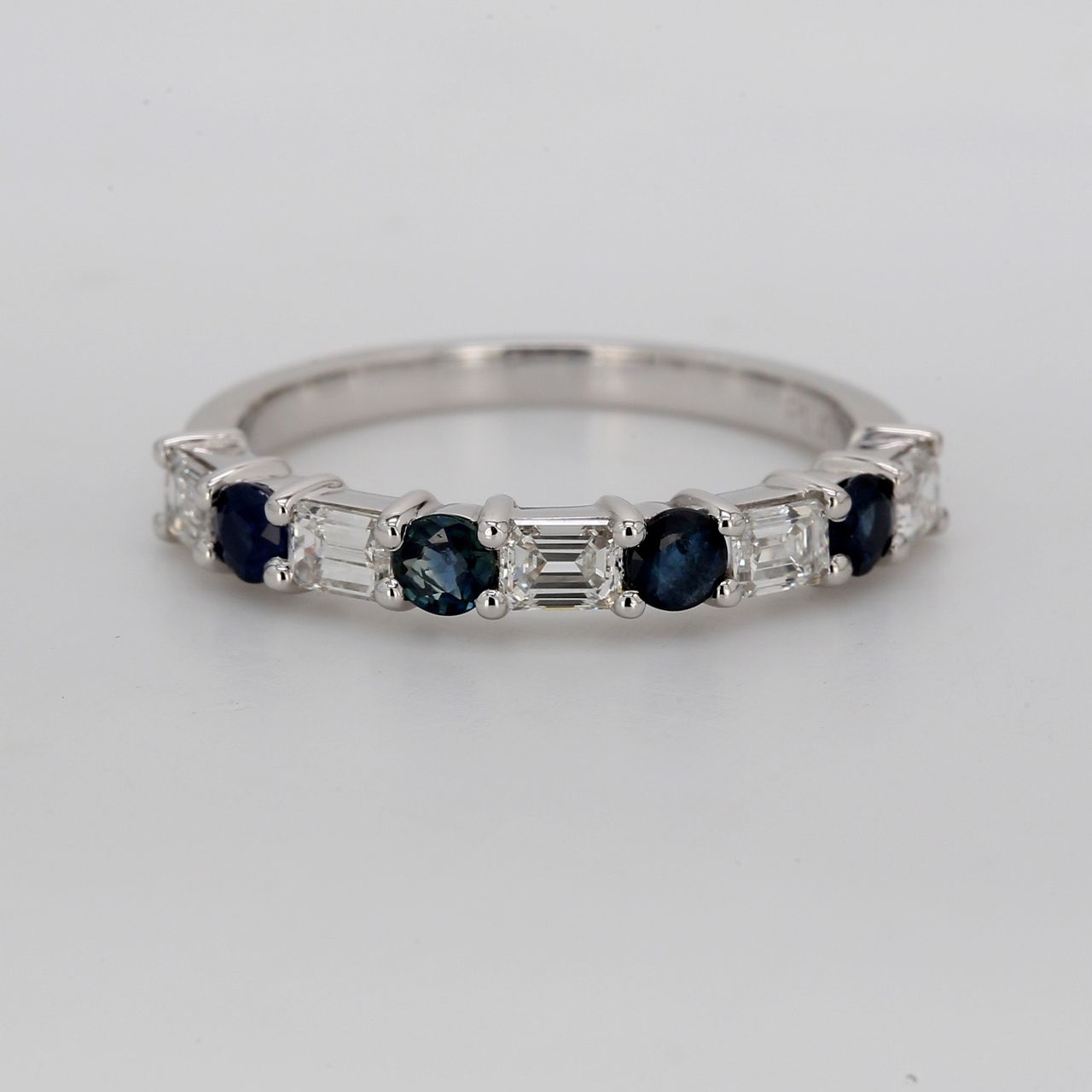 Band in platinum with alternating prong set emerald cut diamonds and round shape sapphires.  D0.76ct.t.w.  Sapphires 0.53ct.t.w.