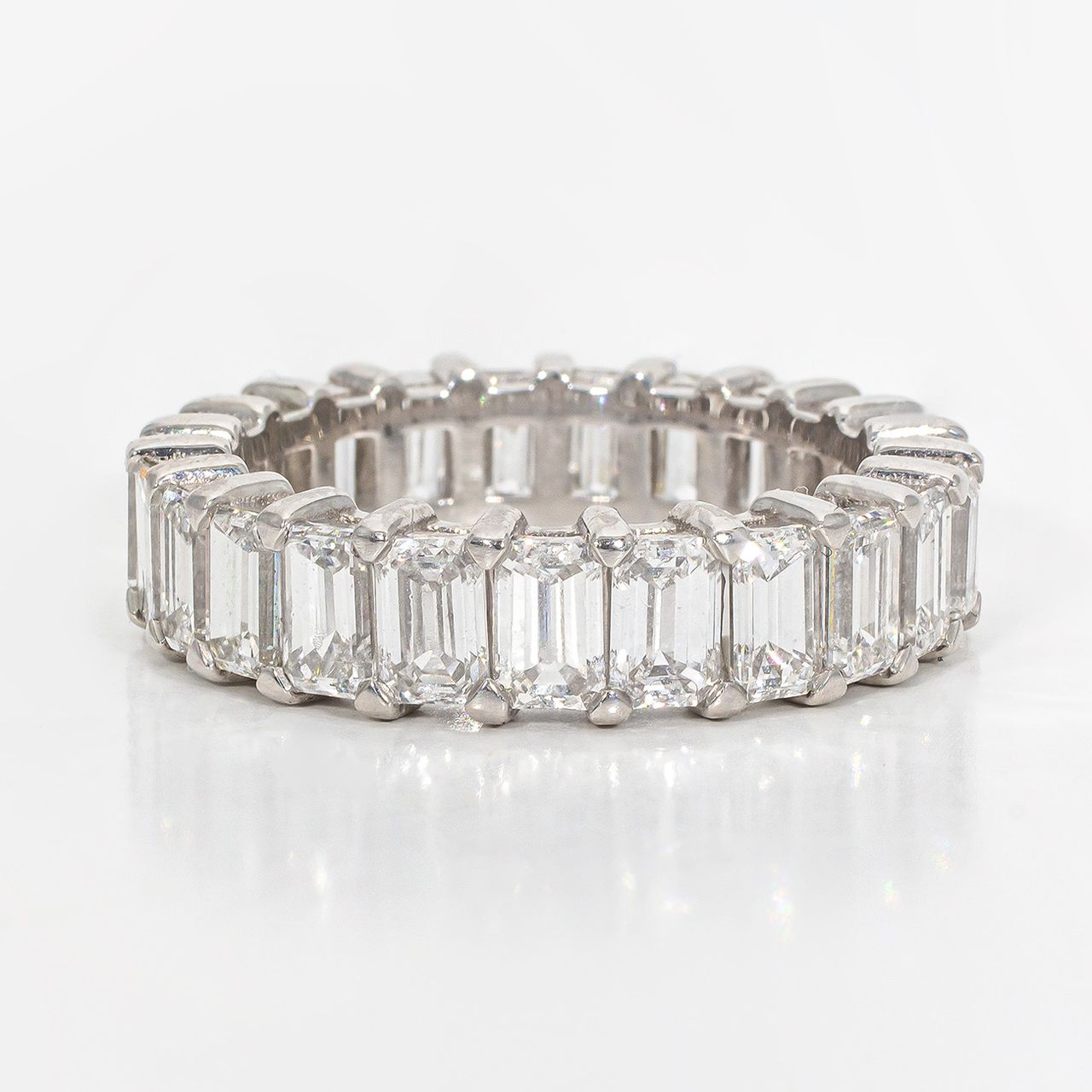 Eternity band in platinum with shared prong set (23) emerald cut diamonds.  D4.61ct.t.w.  Size 6
