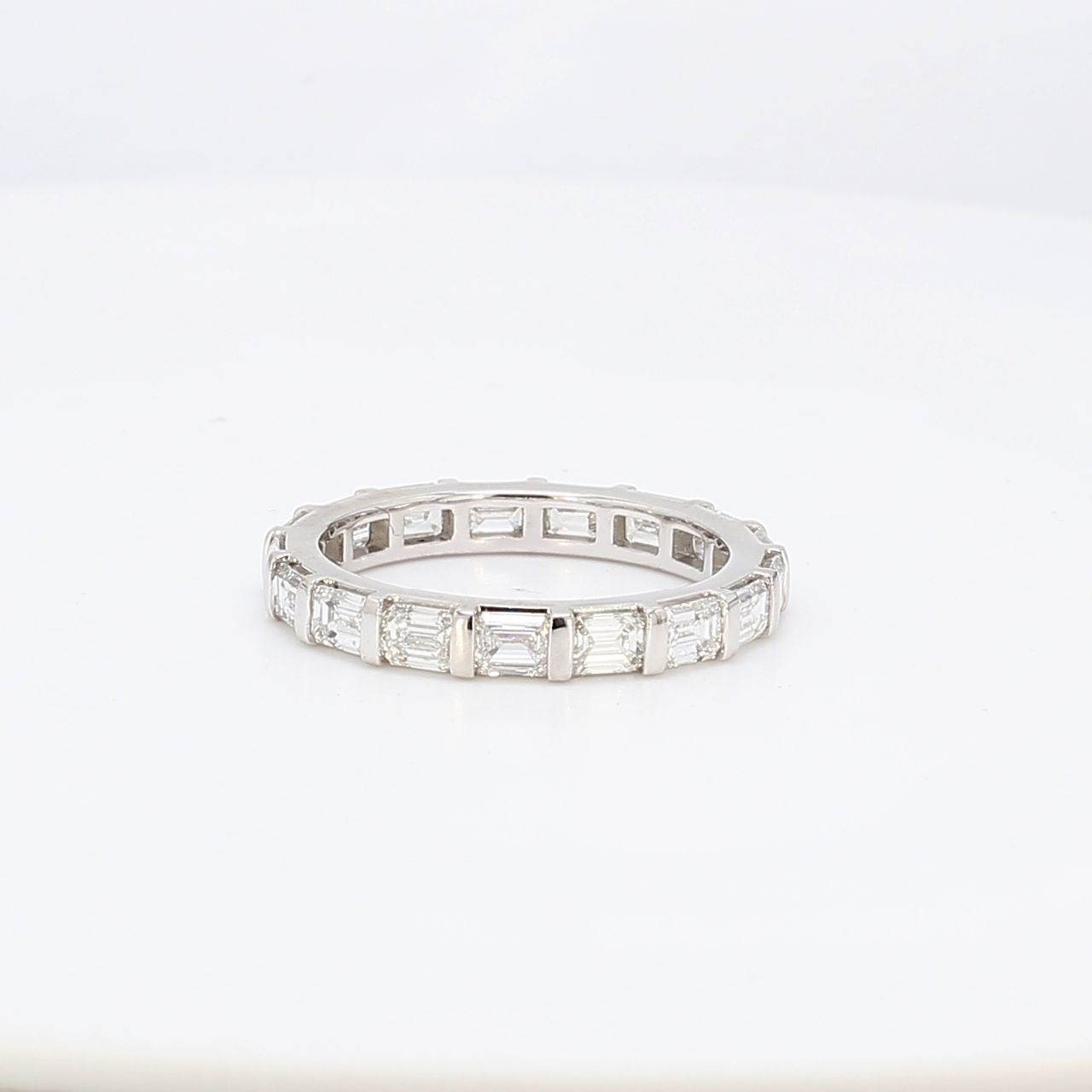 Eternity band east to west style in platinum with channel set emerald cut diamonds.  D3.21ct.t.w.  Size 8