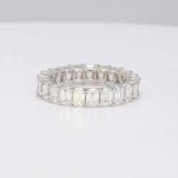 Eternity band in platinum with U-prong set (23) emerald cut diamonds.  D4.32ct.t.w.  Size 6.75