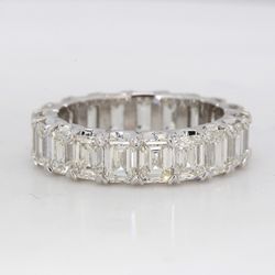 Eternity band in platinum with shared V-prong set single basket emerald cut diamonds.  D5.75ct.t.w.  Size 5.25
