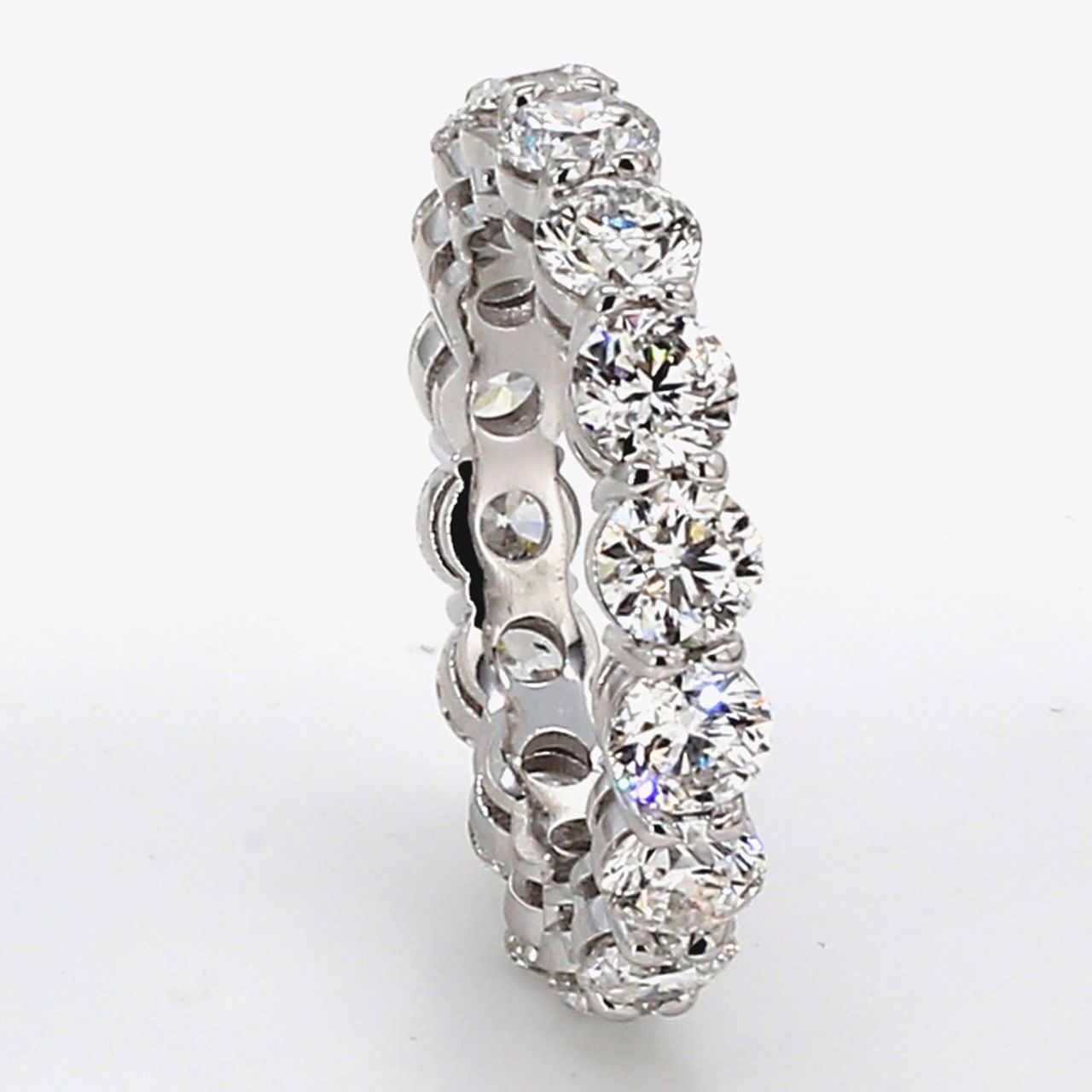 Eternity band in platinum w/ basket prong set (16) round diamonds.  D4.80ct.t.w.  Size 6.75