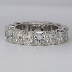 Eternity band in platinum with eagle claw prong set F+/VS+ (16) radiant cut diamonds.  D7.79ct.t.w.  Size 5.5