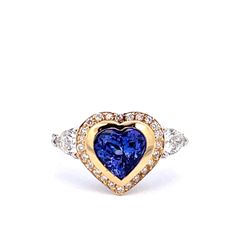 Ring in 18K WG with prong set pear shapes on the sides, prong set round diamonds & heart shaped tanzanite center.  D1.49ct.t.w.  (Tanzanite - 2.09ct.)