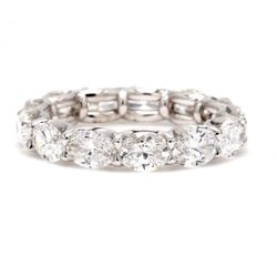 East to west style eternity band in platinum with shared U-prong set oval diamonds.  D3.27ct.t.w.  Size 5.75