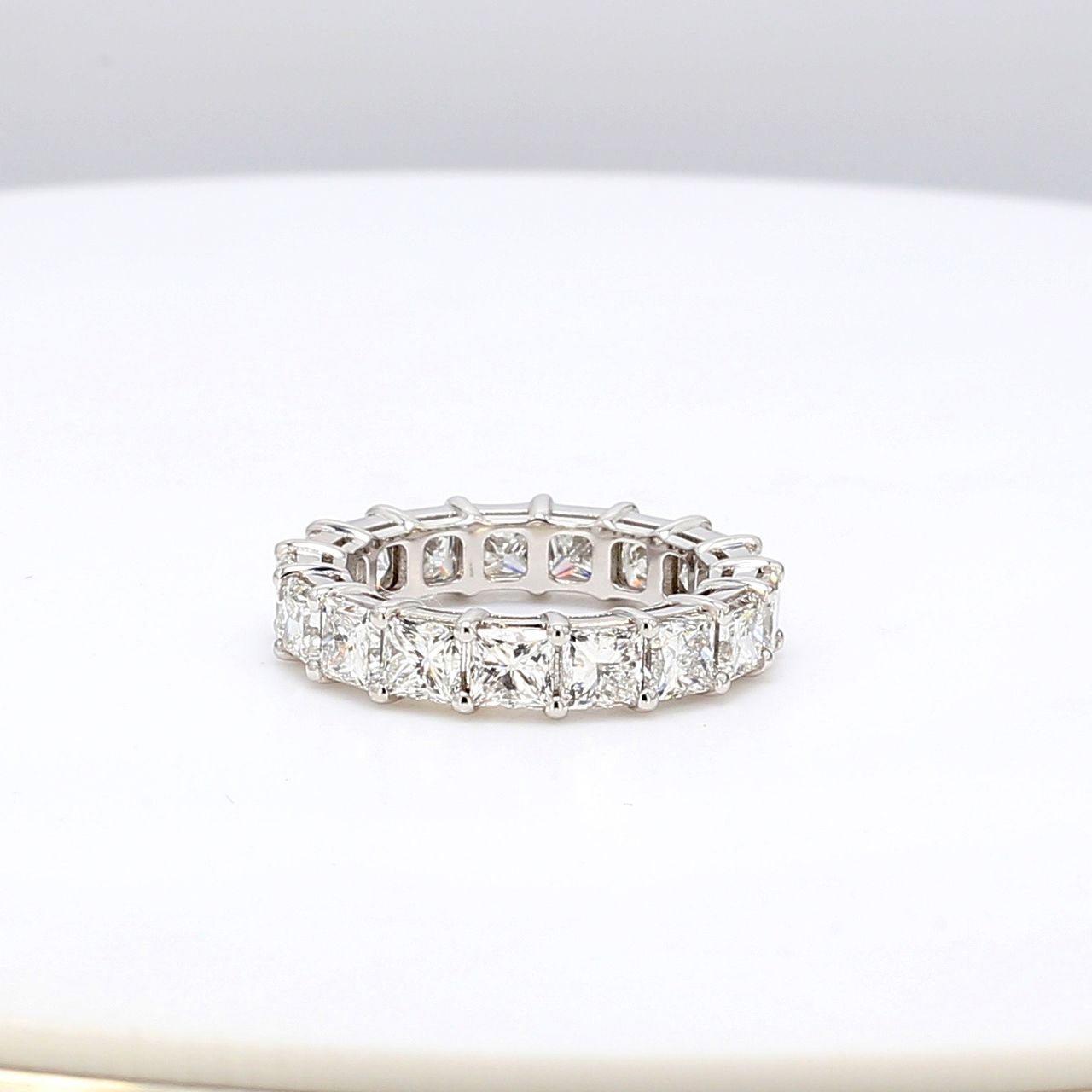 Eternity band in platinum with shared prong basket set (17) princess cut diamonds.  D5.16ct.t.w.  Size 4.75