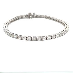 7' Tennis bracelet east west style in 18K WG with open basket prong set (47) emerald cut diamonds.  D5.98ct.t.w.