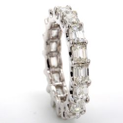 East to west style eternity band with U-prong set F-G/VS (17) emerald cut diamonds.  D4.02ct.t.w.  Size 5