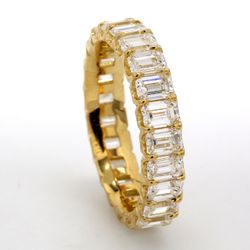 Eternity band in 18K YG with shared U-prong set (23) emerald cut diamonds.  D3.92ct.t.w.  Size 6