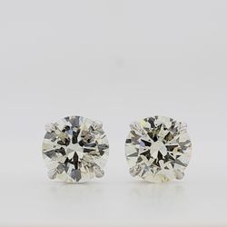 Screw back stud earrings with 4-prong set round diamonds.  D6.01ct.t.w.