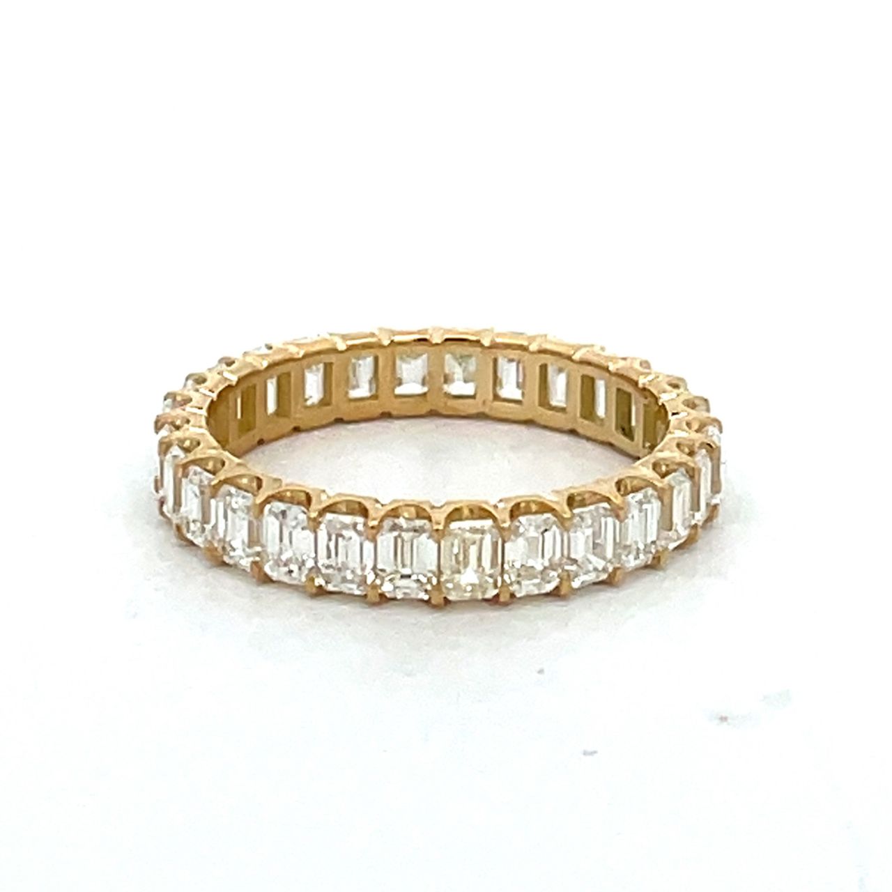 Eternity band in 18K YG with prong set (28) emerald cut diamonds.  D2.48ct.t.w.  Size 6.25