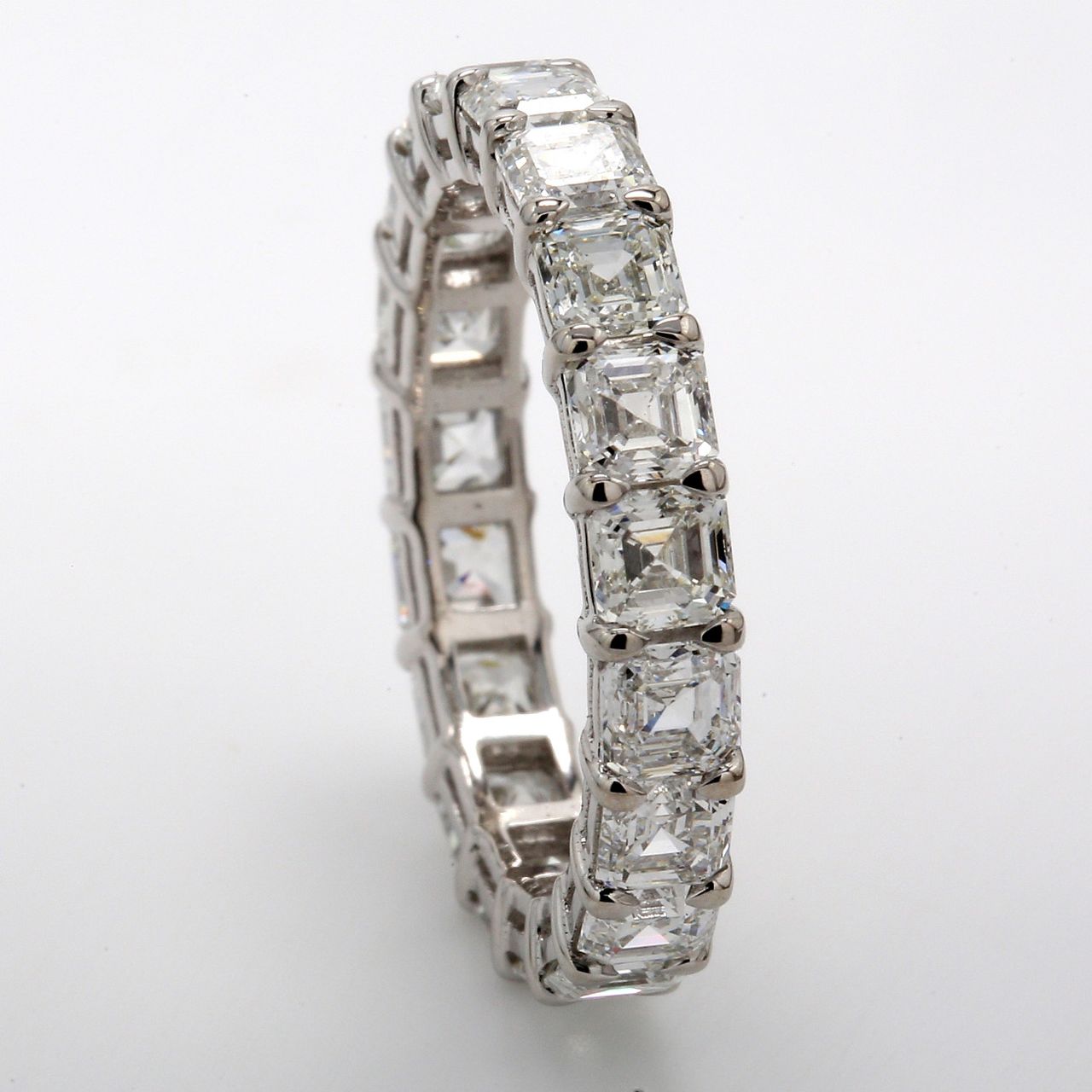 Eternity band in platinum with shared basket prong set (19) asscher cut diamonds.  D3.88ct.t.w.  Size 6.5