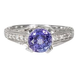 Engraved antique style ring in platinum with pave set round diamonds and U-prong set round shaped tanzanite center stone.  D0.52ct.t.w.  Tanzanite 1.46ct.