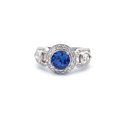 Halo ring in platinum with pave set rounds, bezel set pear shape diamonds, and 4-prong set round shape tanzanite center.  D1.03ct.t.w.  (Tanzanite - 1.70ct.)