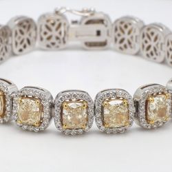 7' Halo tennis bracelet in 18K two-tone with prong set rounds around (20) fancy yellow cushion cut diamond center stones.  D23.97ct.t.w.  (Center - 19.96ct.t.w.)