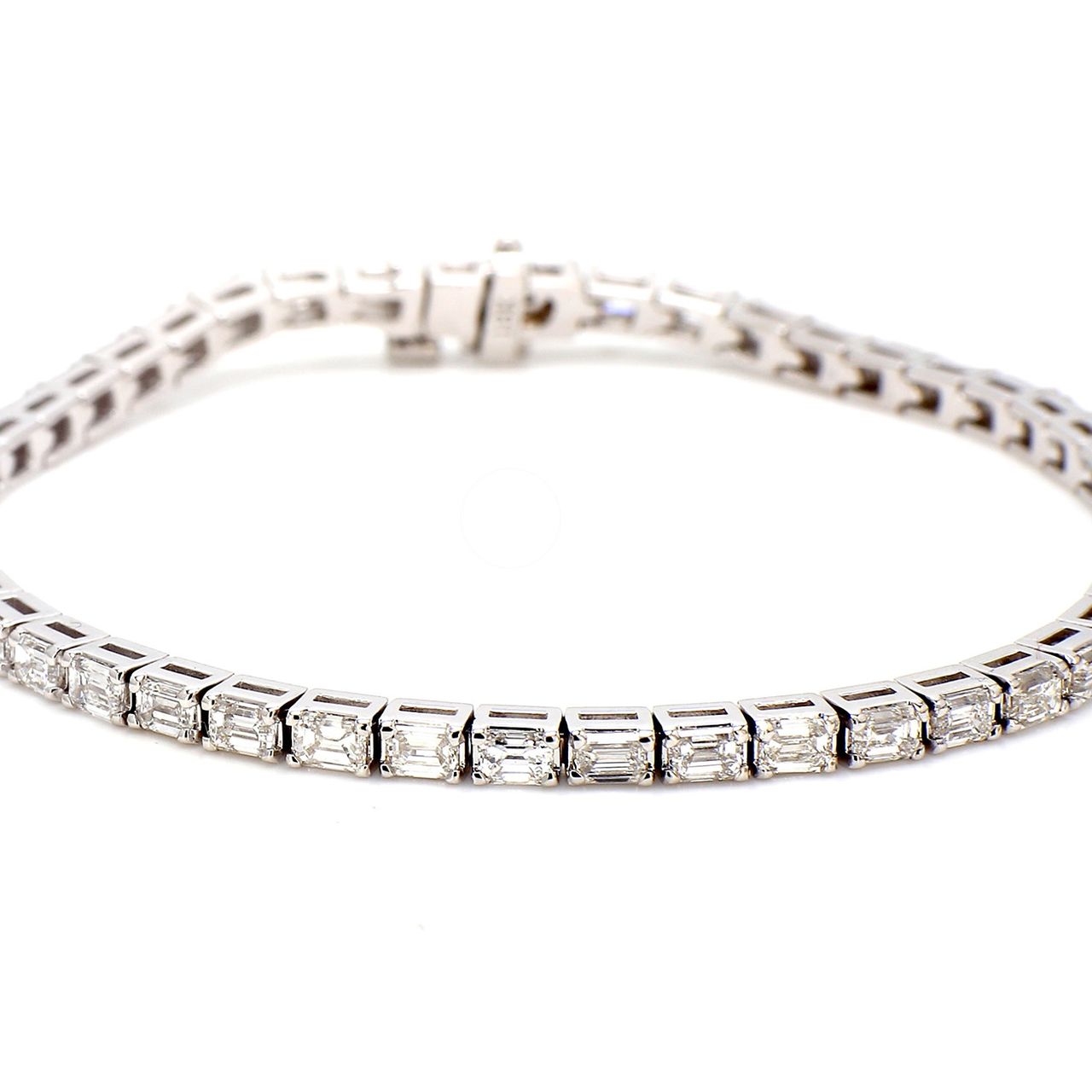7' Tennis bracelet east to west style in 18K WG with basket prong set (47) emerald cut diamonds.  D5.56ct.t.w.