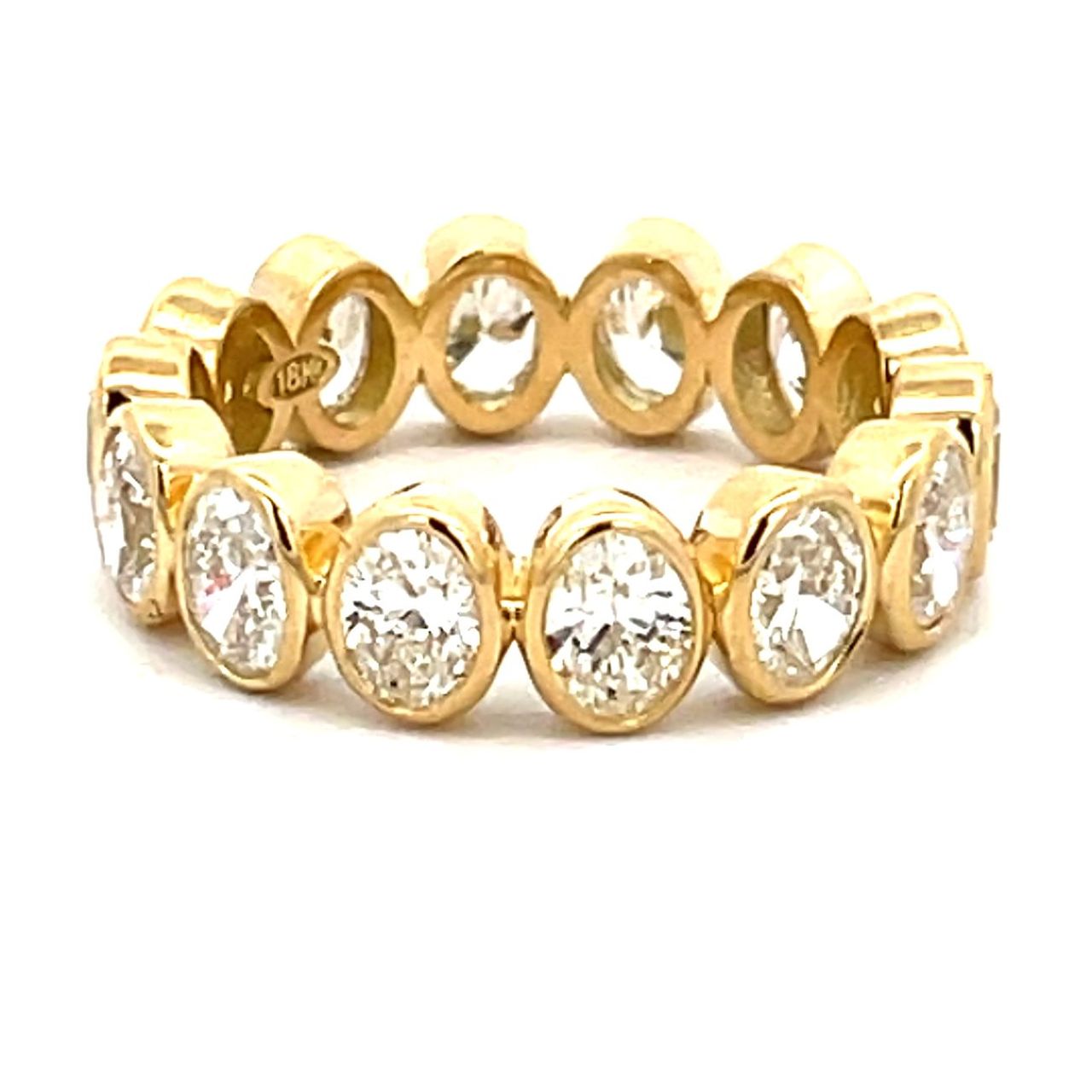 Eternity band in 18K YG with bezel set (14) oval diamonds.  D3.25ct.t.w.  Size 6