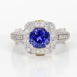 Antique style ring in Platinum and 18K YG linings with pave and bezel set round diamonds, and 4-prong set round shaped tanzanite center stone.  D1.52ct.t.w.  Tanzanite 1.40ct.