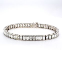 7' Tennis bracelet in platinum with channel set (50) emerald cut diamonds.  D15.90ct.t.w.