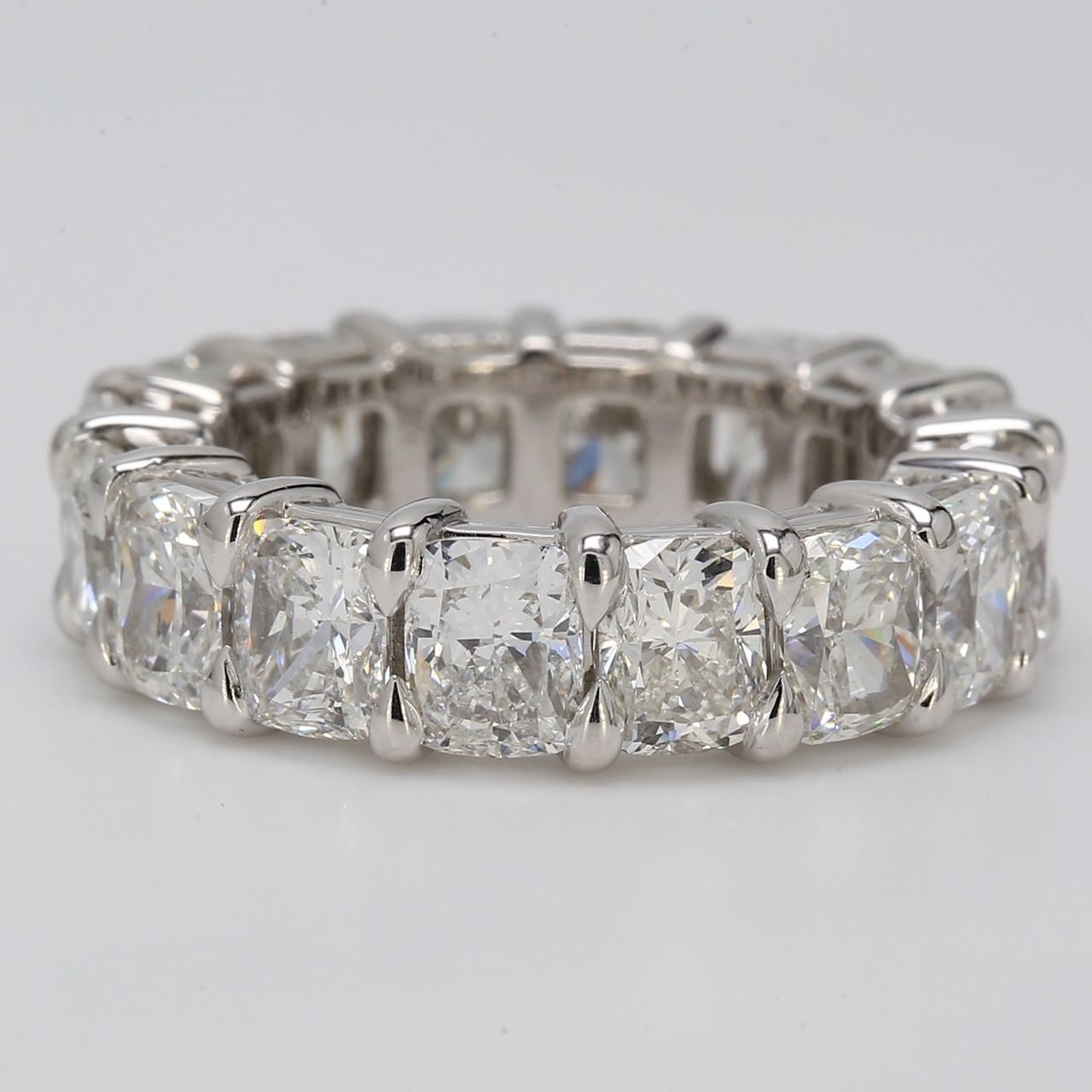 Eternity band in platinum with shared prong basket set elongated F+/VS (16) cushion cut diamonds.  D8.00ct.t.w.  Size 5.25
