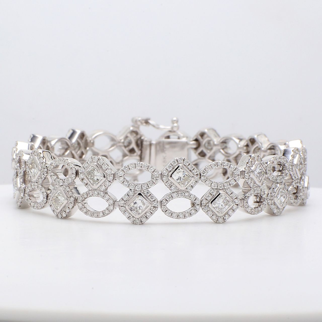 7' Designer bracelet in 18K WG with pre-set rounds & bezel set radiant cut diamonds.  D7.62ct.t.w.