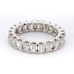 Eternity band in platinum with shared U-prong set emerald cut diamonds.  D4.42ct.t.w.  Size 5.25