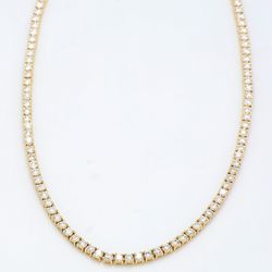 18' Tennis necklace in yellow gold with 4-prong set round diamonds.  D7.16ct.t.w.