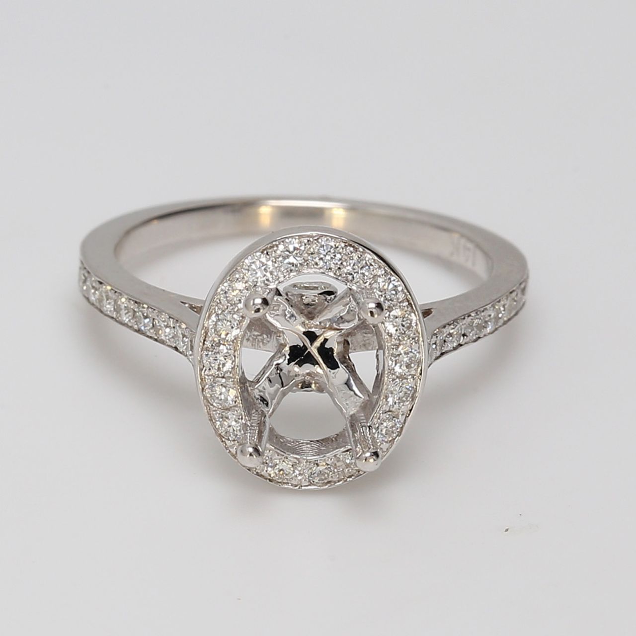 Halo semi-mount with bezel & pre-set round diamonds.  D0.48ct.t.w.