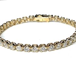 7' Tennis bracelet in yellow gold with illusion style 4-prong set (37) round diamonds.  D5.57ct.t.w.