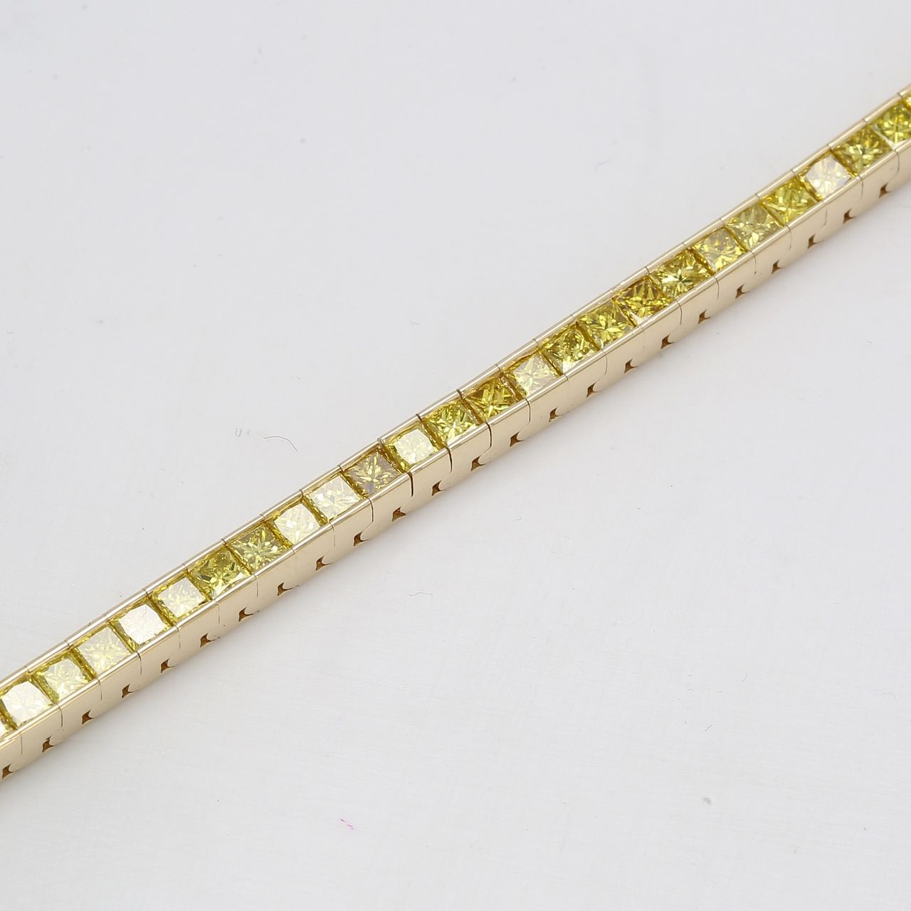 7' Tennis bracelet in 14K YG with channel set princess cut yellow diamonds.  D4.41ct.t.w.