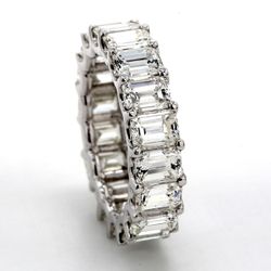 Eternity band in platinum with shared U-prong set (26) emerald cut diamonds.  D3.68ct.t.w.  Size 6