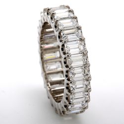 Eternity band in platinum with U-shape prong set (25) emerald cut diamonds.  D5.11ct.t.w.  Size 7