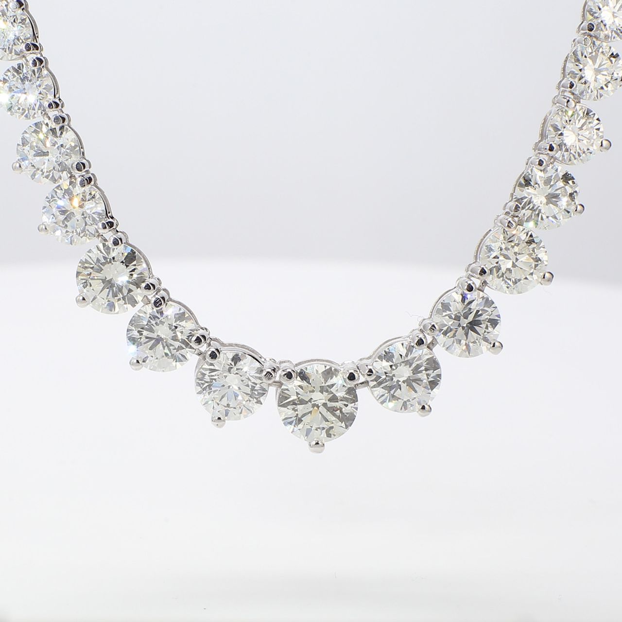 17' Graduated tennis necklace in 18K WG with 3-prong set round diamonds.  D18.63ct.t.w.