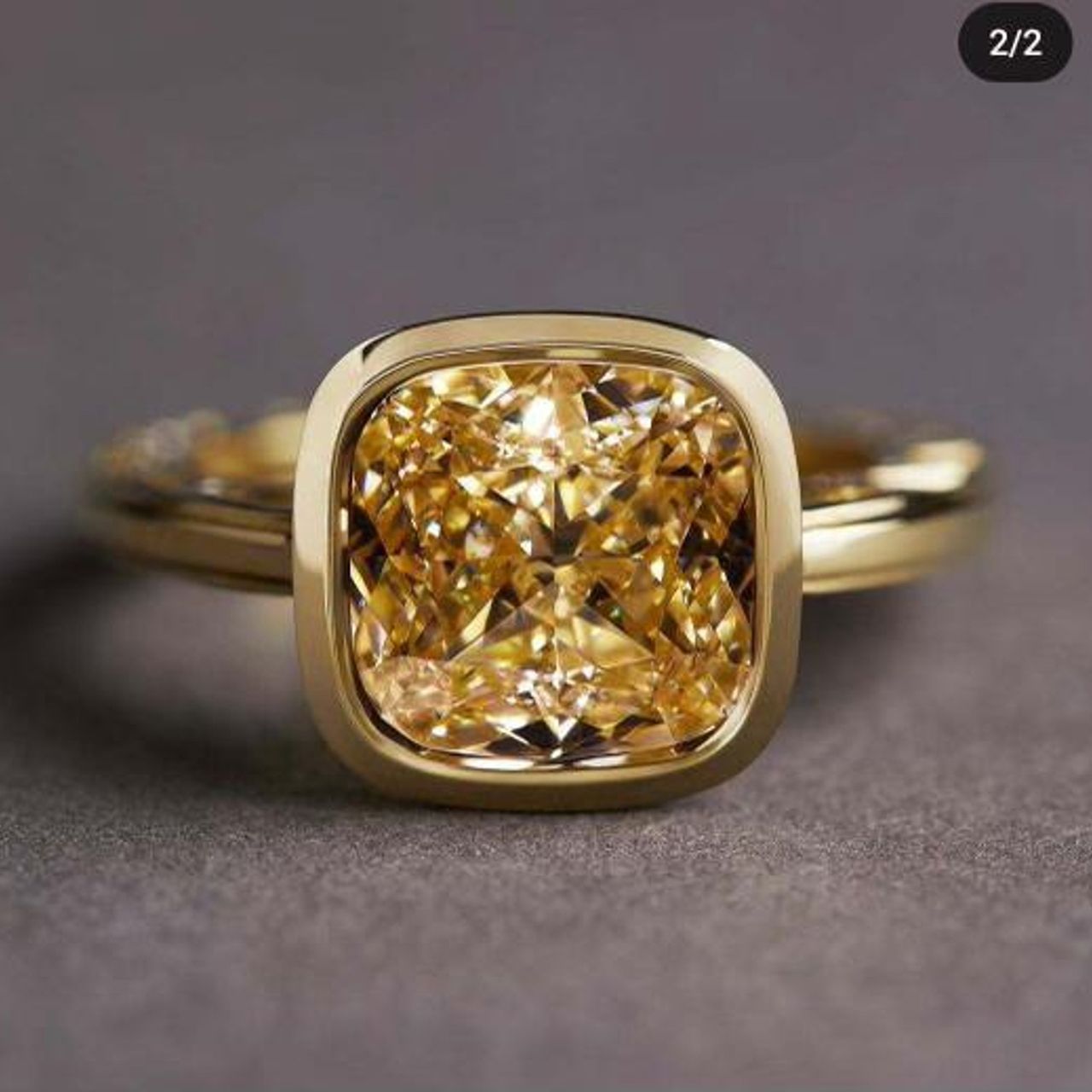 Ring in 18K YG with graduated trilliants on the shank and bezel set FBY/VS2 GIA certified cushion cut diamond center.  D6.03ct.t.w.  (Center - 5.03ct.)