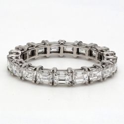 East to west style eternity band in platinum with 4-prong set (19) emerald cut diamonds.  D2.68ct.t.w.  Size 6